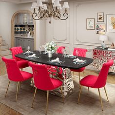 a dining room with red chairs and a black table