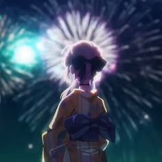 a person standing in front of fireworks with their back to the camera, looking at something