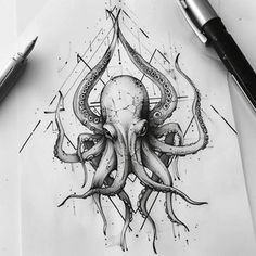 an octopus tattoo design on paper next to a pen and ink drawing pencils are in the background