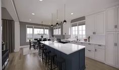 a large kitchen with an island and bar stools