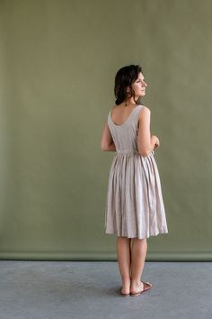 Summer Beige Sleeveless A-line Dress, Summer Knee-length Beige Sundress, Beige Knee-length Sundress For Summer, Beige Sleeveless Midi Dress For Garden Party, Elegant Beige Knee-length Sundress, Elegant Knee-length Beige Sundress, Elegant Flax Colored Linen Day Dress, Summer Linen A-line Sleeveless Dress, Beige Sleeveless Sundress For Daywear