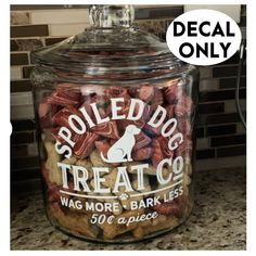 a jar filled with dog treats sitting on top of a counter