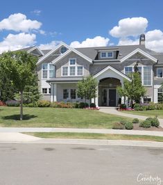 a large house with lots of windows and landscaping