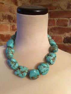 This stunning 18 inch necklace consists of turquoise howlite beads. This necklace is absolutely beautiful!  Please note that there are natural imperfections in the craftsmanship of the pendant as well as natural imperfections in the beads.  The necklace weights approximately 12 ounces and promises to make a statement! Color may vary slightly due to the color calibration of each individual monitor. The pictures simply cannot capture the detail and the beauty of this necklace. Turquoise Necklace With Natural Round Beads, Elegant Turquoise Necklace With Large Beads, Beaded Howlite Turquoise Necklace With Round Beads, Artisan Turquoise Beaded Necklaces With Stones, Turquoise Howlite Beaded Necklace With Gemstone Beads, Beaded Howlite Turquoise Necklace Gift, Beaded Turquoise Howlite Necklace As Gift, Beaded Turquoise Howlite Necklace For Gift, Turquoise Howlite Gemstone Beaded Necklaces