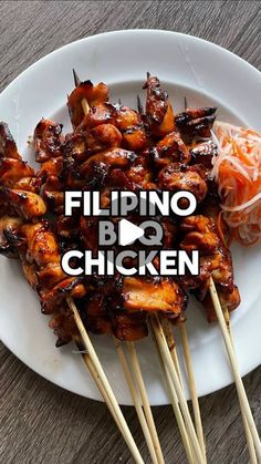 chicken skewers on a white plate with chopsticks