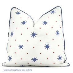 a white pillow with blue and red stars printed on it's side, against a white background