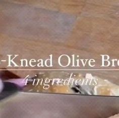 a person holding a knife in their hand with the words k - knead olive bread ingredients on it