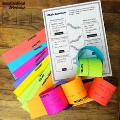 several different colored sticky notes on top of a wooden table