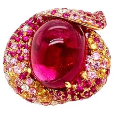 This gorgeous cabochon pink tourmaline ring is custom made that is designed to capture everyone's attention. The pink and yellow sapphires are scattered along with the round brilliant diamonds to give the ring a strawberry shortcake appearance. The translucent pink tourmaline captivate the eyes and this is a must have ring for you collection. Size: 6.25 (can be resize) Tourmaline and Sapphires: 28.81 cts, Cabochon / Round Diamonds: 0.71 ct, Round Brilliant Metal: 18k Rose Gold Pink Diamond Ring, Ring Rosegold, Bath And Body Works Perfume, Jewelry Real, Pink Tourmaline Ring, Rose Gold Pink, Gold Ring Sets, Cabochon Ring, 18k Yellow Gold Ring