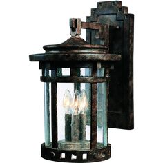 an old fashioned wall light with three lights on it's side and one is turned on