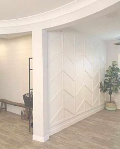 an empty living room with white walls and wood flooring on the inside, while a blue door is in the background