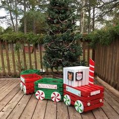 an outdoor christmas decoration made out of cardboard boxes and candy canes on a wooden deck