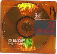 the cd is in its plastic case and has an orange disc with yellow lights on it