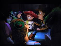 the toy story characters are talking to each other in front of a dark room full of stuffed animals