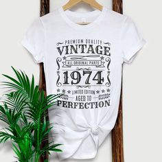 If you're looking for a unique and stylish way to wear on your 50th Birthday, then check out our vintage 1974 shirt! This shirt features a soft, comfortable fabric and a cool, retro design. Whether you're dressing up for a special occasion or just want to feel nostalgic, this shirt is perfect for you. Our vintage 1974 shirt is also great for birthdays, anniversaries, or any other special day. So don't wait any longer - order your vintage 1974 shirt today! 1970S, Vintage 1974 Shirt, Vintage 1974 Shirt, Vintage T Shirt 70S, 1974 birthday TShirt, Retro Birthday Tee, 1974 Birthday Shirt, 50th Birthday Gift, 50Th Birthday Shirt, Vintage Birthday Tee, 1974 Gift Tee, Classic 1974 Shirt, Vintage T Shirt  #Vintage1974 #1974Birthday #RetroStyle #VintageTShirt #50thBirthday #1974Shirt #ClassicDesign Vintage Birthday T-shirt With Text Print, Classic Graphic Print T-shirt For Birthday, Vintage White T-shirt For Birthday, Vintage Text Print Top For Birthday, Vintage Cotton T-shirt As Gift, Vintage Letter Print Tops For Anniversary, Classic Letter Print T-shirt For Anniversary, Vintage Short Sleeve Tops With Lettering, Retro White Tops For Anniversary