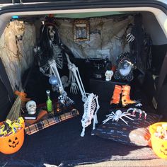 a trunk filled with halloween decorations and skeletons