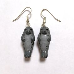 two small gray bears are hanging from silver earwires