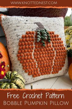 a crocheted pumpkin pillow sitting on top of a table