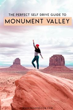 a person standing on top of a rock in the desert with their arms raised up