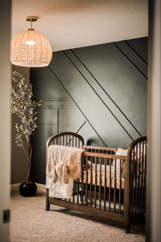 a baby's crib in the corner of a room next to a lamp