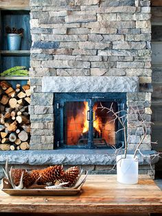 a fire place with logs in front of it