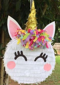 a unicorn pinata hanging from a tree