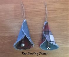 two pieces of fabric hanging from strings on a wooden surface with the words sewing fixes written below them