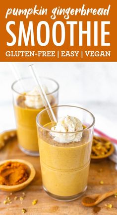 pumpkin gingerbread smoothie with whipped cream in two glasses on a cutting board next to spoons