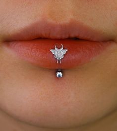 a woman's nose with a silver nose ring attached to the end of her lip