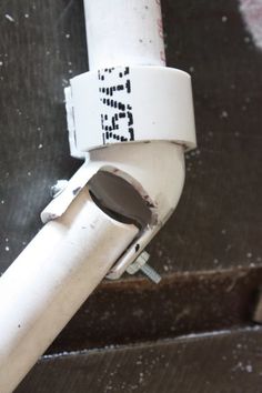 a close up of a white pipe with a sticker on it's side