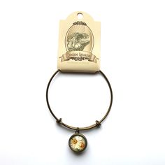 "Simple, vintage inspired adjustable charm bracelet with brass wire and brass setting. Double sided charm with same image on either side, decoupaged under glass cabochons. *Image area 16mm (about the size of a dime) *Bracelet adjusts from about 4\" to about 10\". WHOLESALE AND CONSIGNMENT: I am proud to partner with retailers across the continent. If you purchase for a brick and mortar location please convo me for a copy of a my wholesale line sheet. I am pleased to consider both wholesale and w Flower Cottagecore, Line Sheet, Mermaid Images, Blue Jay Bird, Brick And Mortar, Bracelet Bangle, Red Bead, Embroidery Floss, Daisy Flower