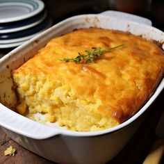 a casserole dish with corn and cheese in it