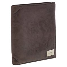 A luxury essential from Loewe, this fine leather bifold safely stores cards and cash with a clean design. The soft brown leather exterior develops character with use, while retaining the iconic logo stamped on the front corner. Featuring interior slots and pockets, it measures just over 3 inches wide to fit easily in any pocket or bag. An Instagram-worthy addition for any collection. Elegant Brown Trifold Wallet With Rfid Blocking, Elegant Brown Trifold Wallet For Travel, Brown Textured Leather Wallet For Business, Brown Textured Leather Business Wallet, Elegant Brown Trifold Wallet With Leather Lining, Elegant Brown Textured Leather Wallet, Modern Brown Trifold Wallet For Formal Use, Modern Brown Trifold Wallet For Formal Occasion, Luxury Brown Leather Trifold Wallet