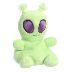 a green stuffed animal with purple eyes