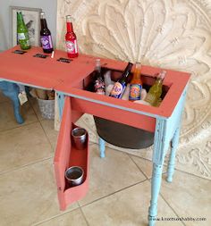 a small table with bottles and cups on it