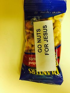 a bag of food sitting on top of a yellow table next to a sign that says for nuts go nuts