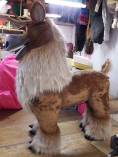 a stuffed animal standing on top of a wooden floor