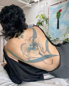 a woman with a flower tattoo on her back