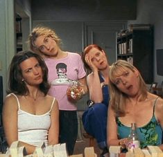 three women sitting at a table with books and drinks in front of them on the television show friends