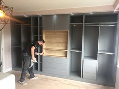 a man standing in front of an open closet