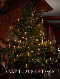 a christmas tree with lights and presents under it