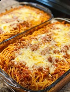 two glass casserole dishes filled with spaghetti and meat sauce, on a counter