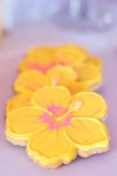 yellow flower cookies sitting on top of a table