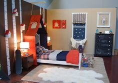 a child's bedroom decorated in orange, blue and white