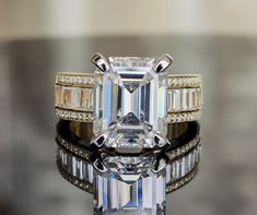 an emerald cut diamond surrounded by two bands