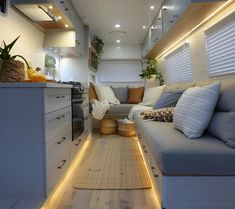 the interior of a camper van is lit up with led lights and wood flooring