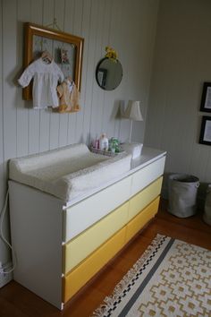 a baby crib in the corner of a room next to a lamp and rug