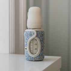 a thermometer sitting on top of a white table next to a window sill