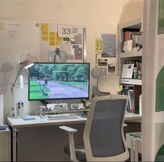 a desk with a computer monitor, keyboard and mouse next to a book shelf filled with books