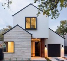 a modern house with two garages in the front and one on the other side